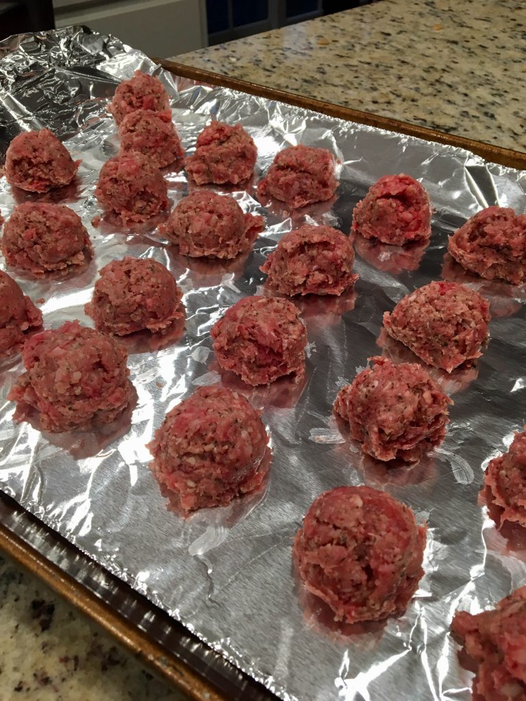 uncooked meatballs on tray