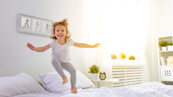 child jumping on bed due to sleep difficulties