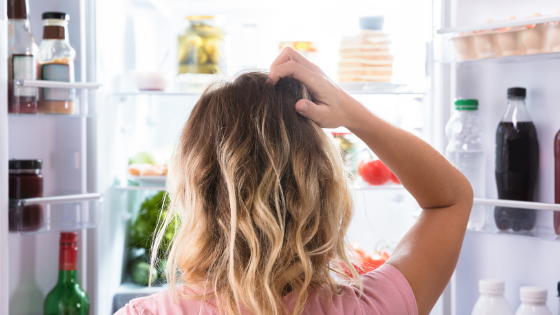 woman looking in fridge