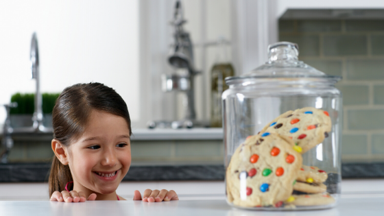 girl looking at a cookie jar for intuitive eating principle of saying yes