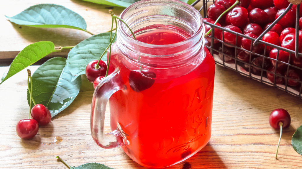 sparkling cherry lemonade served in a jar with cherries