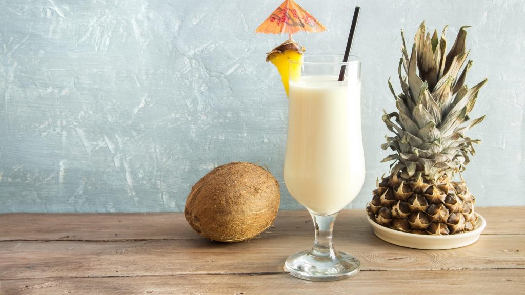 healthy pina colada in glass with straw