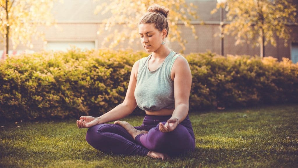 woman meditating as a positive body image behavior