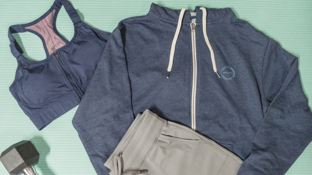 flatlay of HYLETE hoodie, joggers, and sports bra